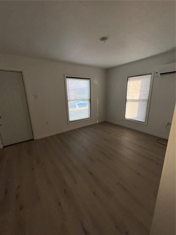 spare room with wood finished floors