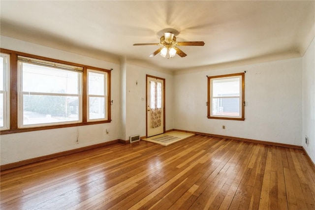 interior space with visible vents, light wood-style floors, baseboards, and ceiling fan