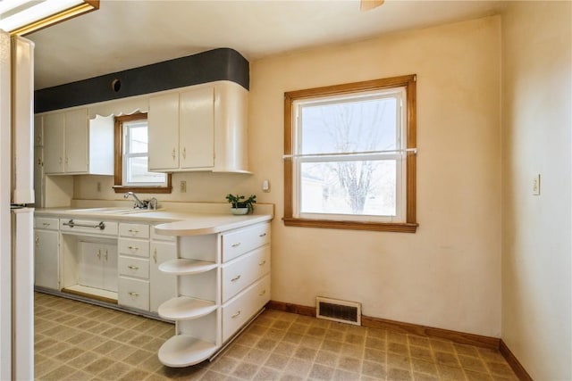 kitchen with open shelves, white cabinets, baseboards, and visible vents