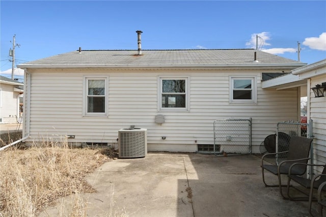 back of house with a patio, a shingled roof, and central AC