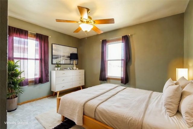 carpeted bedroom with baseboards and a ceiling fan