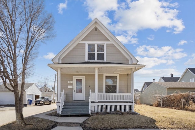 view of front of house featuring a porch and an outbuilding