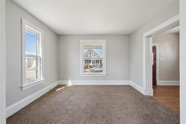 carpeted empty room with baseboards