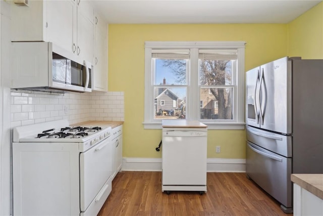 kitchen with white appliances, dark wood-style floors, light countertops, white cabinetry, and backsplash