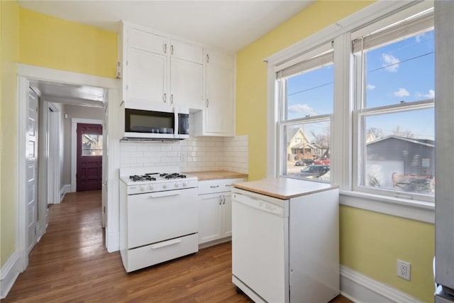 kitchen featuring white appliances, white cabinets, a healthy amount of sunlight, and light countertops