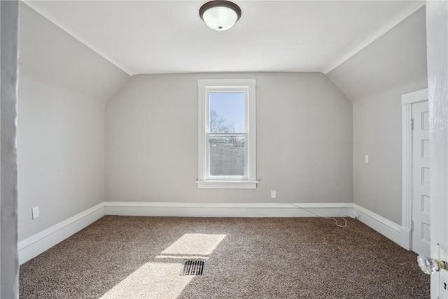 additional living space with lofted ceiling, carpet, and visible vents