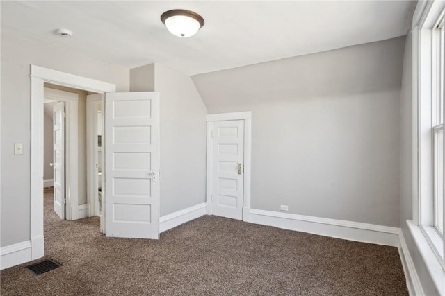 interior space with carpet flooring, baseboards, and visible vents