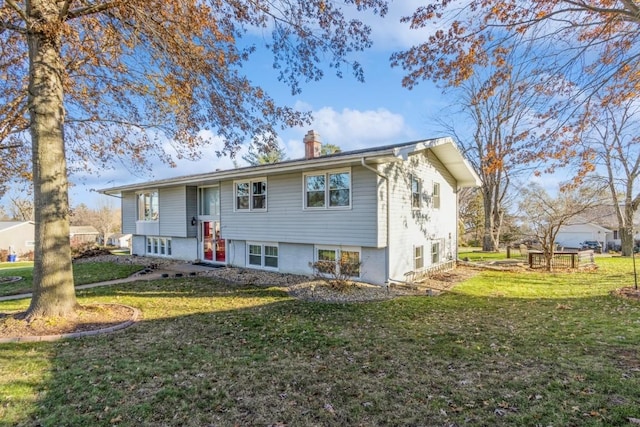 bi-level home with a front yard and a chimney