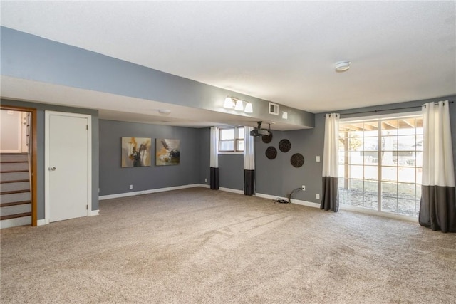 unfurnished living room featuring carpet flooring, baseboards, stairs, and visible vents