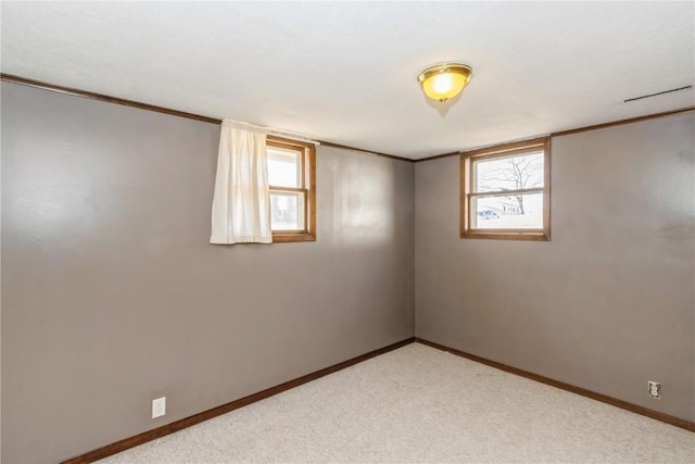 unfurnished room featuring baseboards, light carpet, and ornamental molding