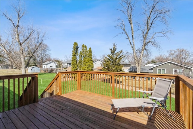 wooden terrace with a lawn and a residential view