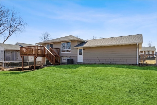 back of property featuring stairway, a lawn, a deck, and fence