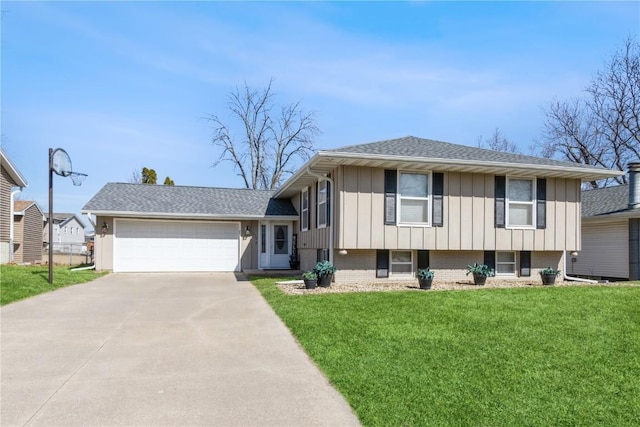 split level home featuring a front yard, roof with shingles, an attached garage, concrete driveway, and board and batten siding