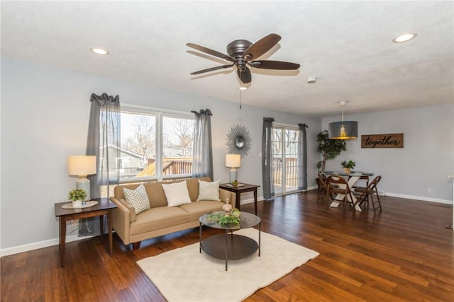 living area with recessed lighting, ceiling fan, baseboards, and wood finished floors