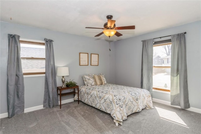 carpeted bedroom with a ceiling fan and baseboards