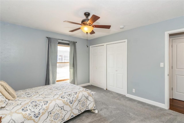 bedroom with ceiling fan, baseboards, carpet, and multiple closets