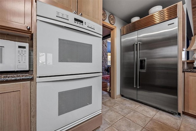 kitchen featuring white appliances and light tile patterned floors