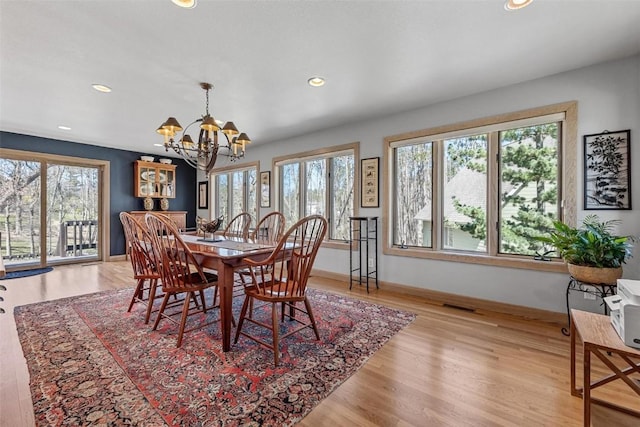 dining area with visible vents, a healthy amount of sunlight, baseboards, and light wood-style floors