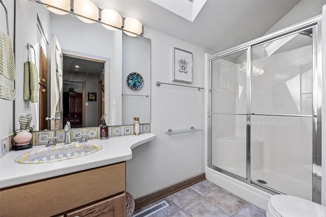 full bathroom with a skylight, toilet, visible vents, and a stall shower