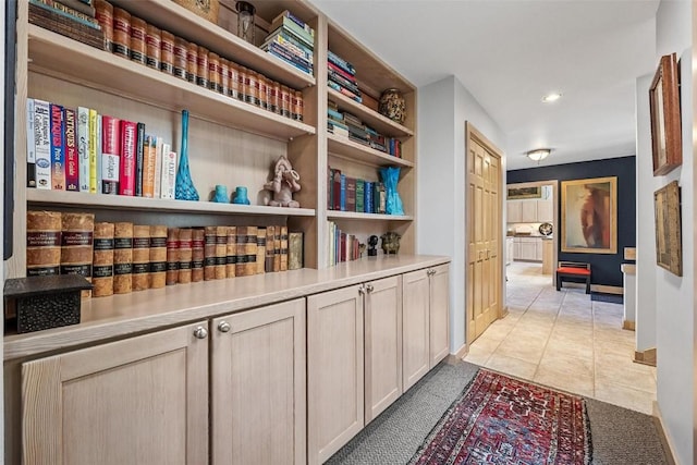 corridor featuring light tile patterned floors, recessed lighting, and baseboards