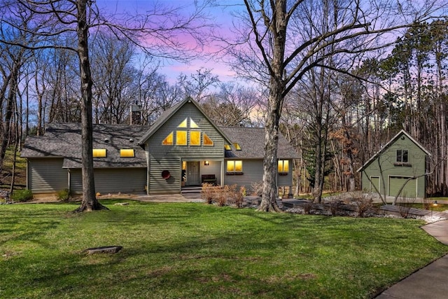 view of front of property featuring a shingled roof, a front yard, a garage, and a chimney