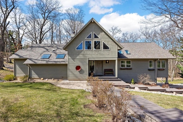 view of front of home featuring a front yard and roof with shingles