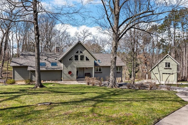 view of front facade with a front yard and roof with shingles