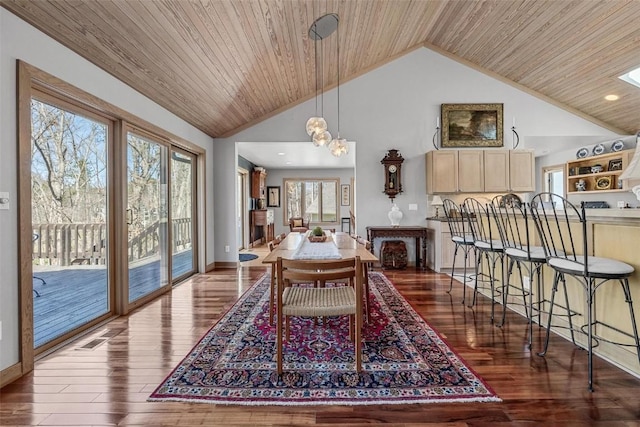 dining room featuring wooden ceiling, wood finished floors, baseboards, and high vaulted ceiling