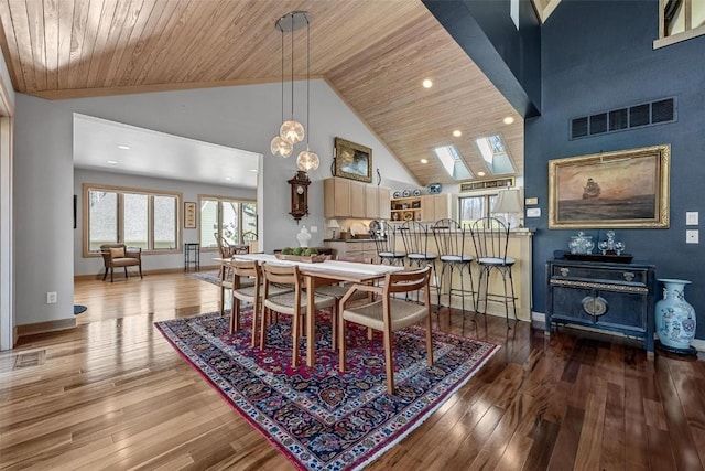 dining room with hardwood / wood-style floors, wooden ceiling, visible vents, and high vaulted ceiling