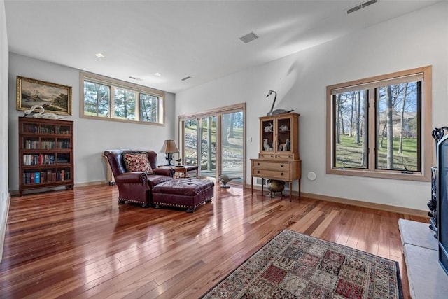 sitting room with visible vents, baseboards, and hardwood / wood-style floors