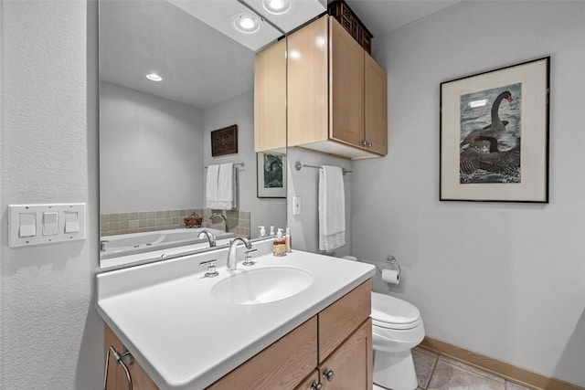 bathroom featuring vanity, tile patterned floors, toilet, and baseboards