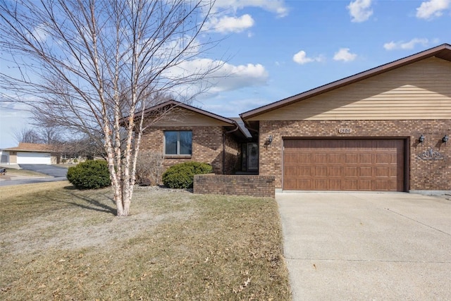 view of front of property featuring a garage, brick siding, concrete driveway, and a front lawn