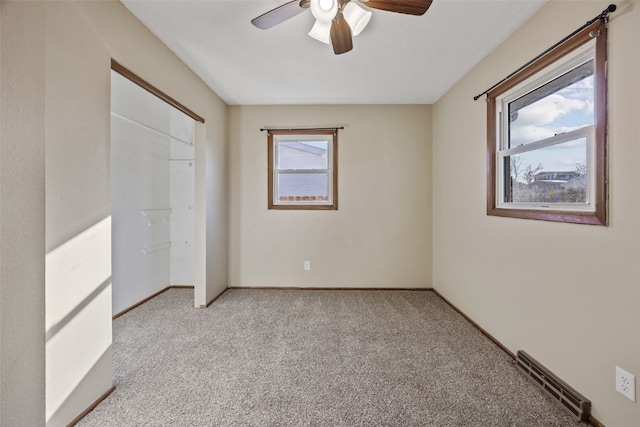 unfurnished bedroom featuring visible vents, a ceiling fan, a closet, baseboards, and light colored carpet