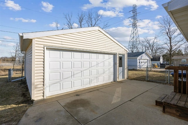 detached garage featuring fence