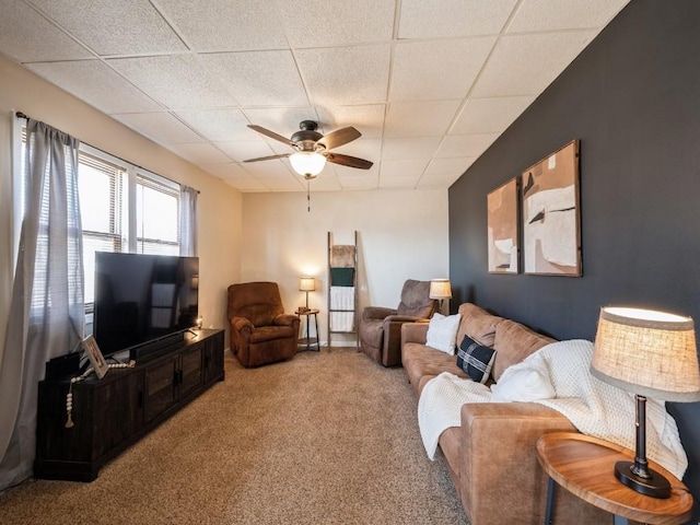 living room with ceiling fan, carpet, and a paneled ceiling