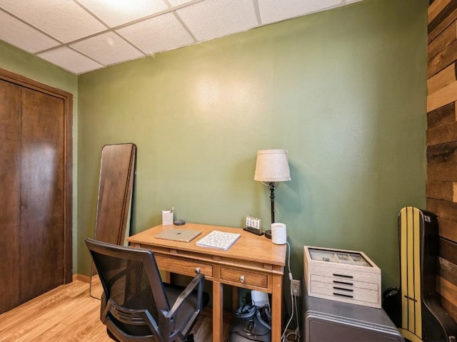 office area featuring a paneled ceiling and light wood-style floors