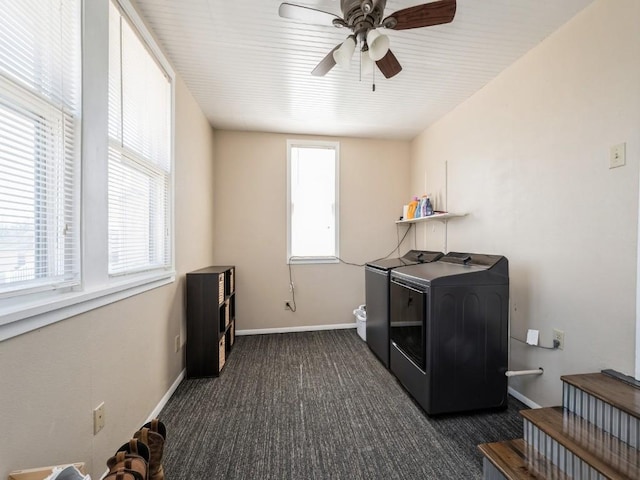 laundry room with washer and clothes dryer, laundry area, dark carpet, and a wealth of natural light