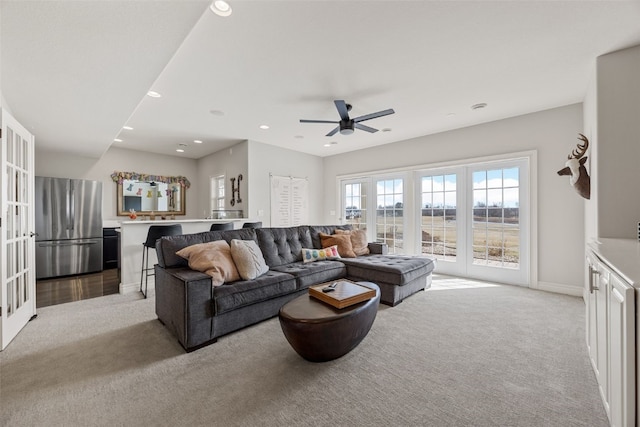 carpeted living area with a ceiling fan, recessed lighting, french doors, and baseboards