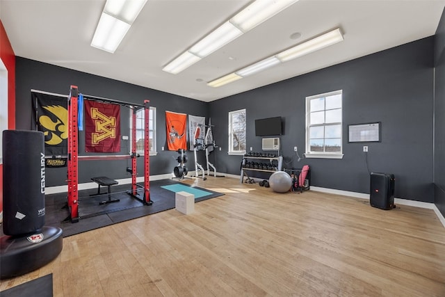 exercise room featuring wood finished floors and baseboards