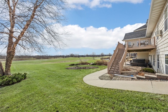 view of yard with cooling unit, stairs, a rural view, a deck, and a jacuzzi