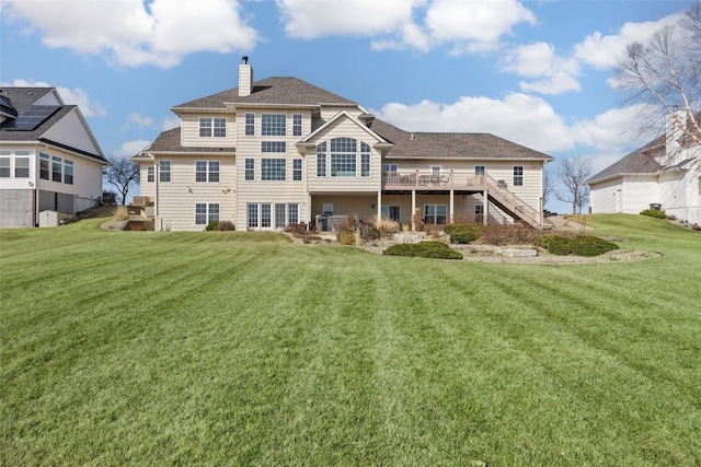 back of property featuring a lawn, a chimney, and stairs