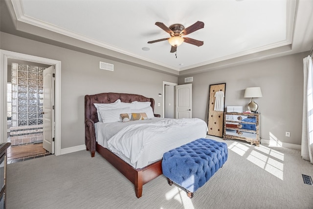 bedroom with baseboards, a raised ceiling, carpet flooring, and crown molding