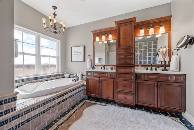 full bathroom with tile patterned flooring, double vanity, an inviting chandelier, a bath, and a sink