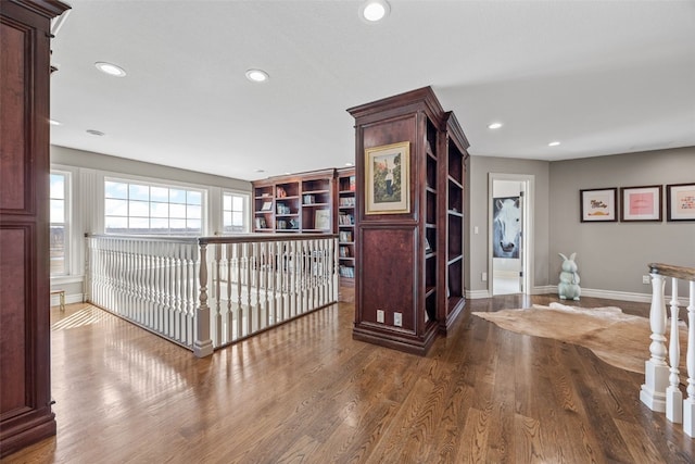 hallway with recessed lighting, baseboards, and wood finished floors