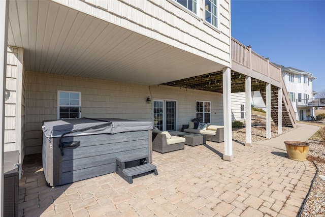 view of patio with stairway, an outdoor hangout area, a hot tub, and a deck