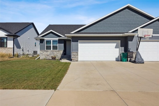 craftsman inspired home featuring a front yard, driveway, an attached garage, central AC, and stone siding