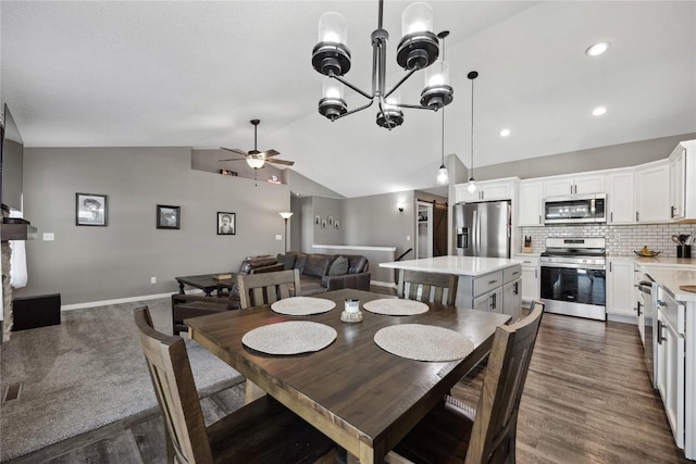 dining area with baseboards, recessed lighting, vaulted ceiling, dark wood-type flooring, and ceiling fan with notable chandelier