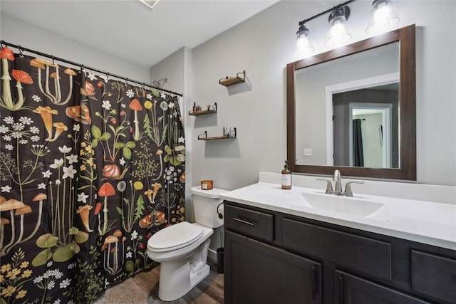full bath featuring vanity and toilet