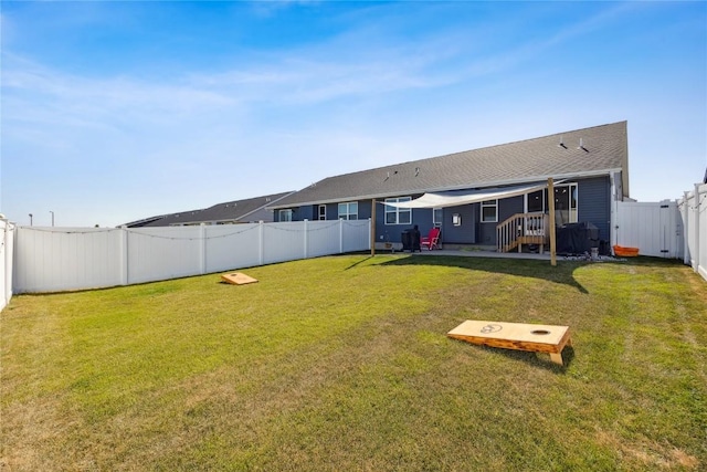 back of house with a patio area, a lawn, and a fenced backyard