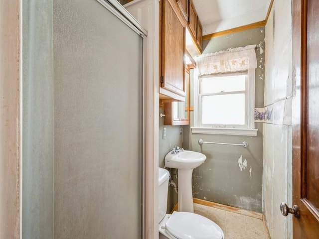 full bath featuring toilet, an enclosed shower, and a sink